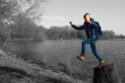 Full length of man in lake against sky