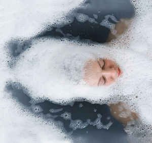 Woman in water and foam