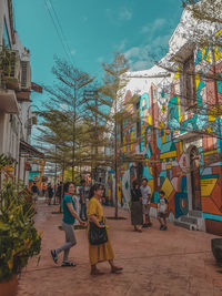 People walking on street against buildings in city