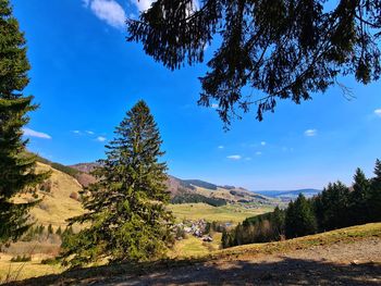 Scenic view of landscape and mountains against blue sky