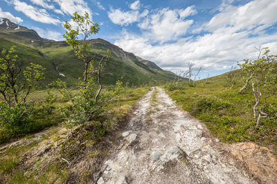 Scenic view of mountains against cloudy sky