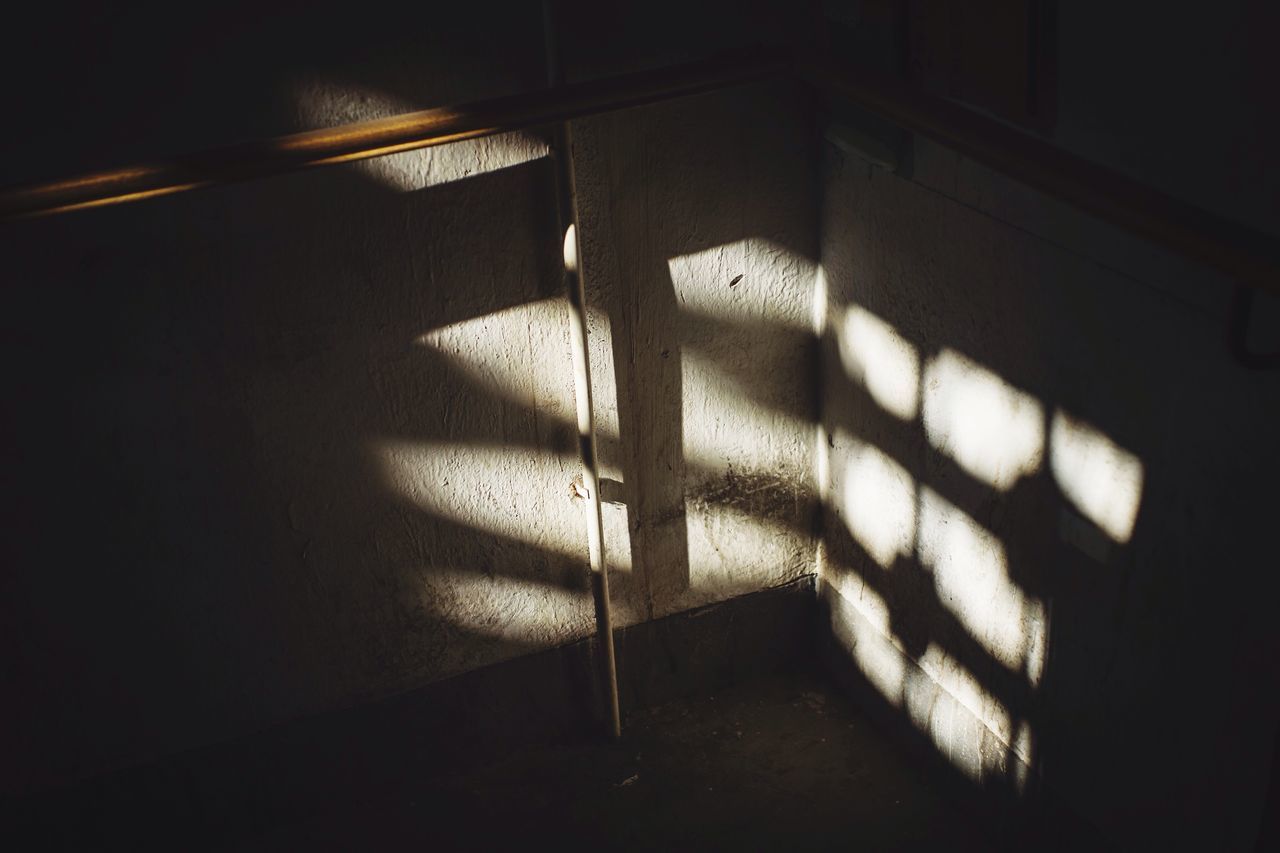 indoors, the way forward, architecture, shadow, built structure, dark, steps, sunlight, staircase, steps and staircases, illuminated, railing, wall - building feature, night, narrow, tunnel, empty, absence, diminishing perspective, transportation