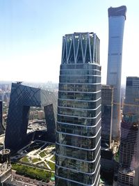 Modern buildings in city against clear sky