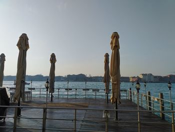 Pier on sea against clear sky