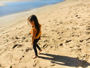 Full length of woman standing on beach