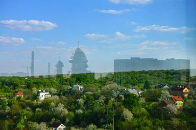 Panoramic view of buildings in city against sky