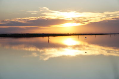 Scenic view of lake against sky during sunset