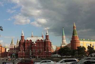 View of buildings in city against cloudy sky