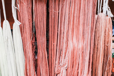 Full frame shot of clothes hanging on wood for sale