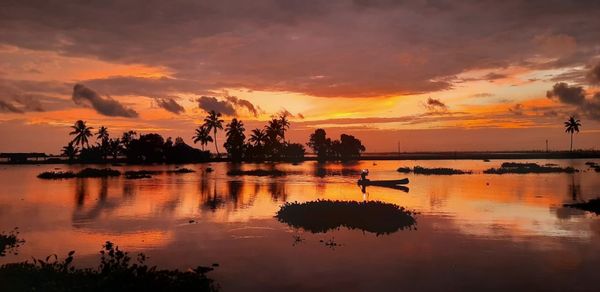 Scenic view of lake against orange sky