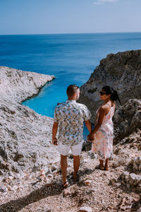 Rear view of couple looking at sea against sky