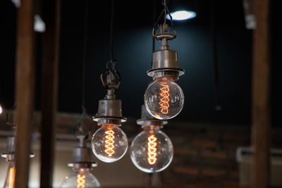 Low angle view of illuminated light bulbs