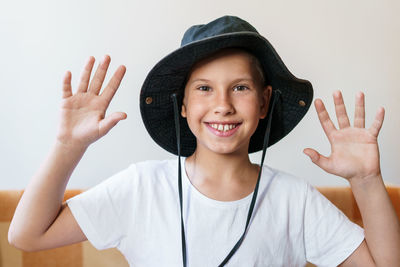 Cheerful school-age boy smiling while looking at the camera. in a white t-shirt