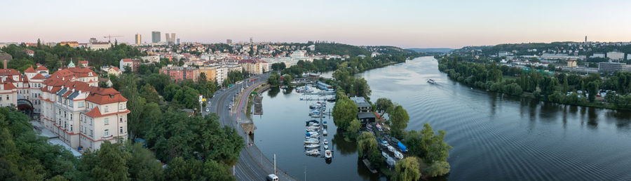 High angle view of river amidst buildings in town against sky