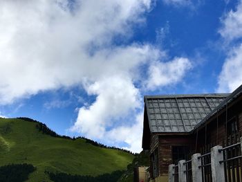 Low angle view of house and buildings against sky