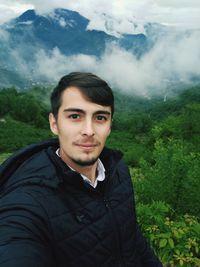 Portrait of young man standing on land