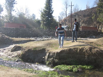 Rear view of people walking on road