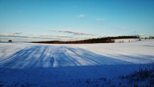 Scenic view of landscape against sky during winter