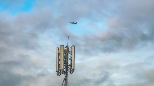 Low angle view of airplane flying against sky