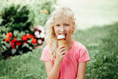 Portrait of cute girl eating ice cream outdoors