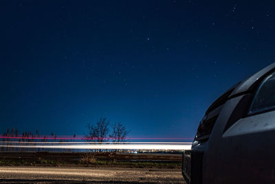 Airplane wing against sky at night