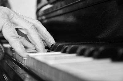 Cropped hand playing piano