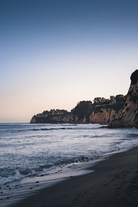 Scenic view of sea against clear sky during sunset