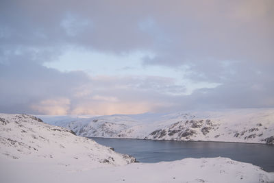 Scenic view of snowcapped mountains against sky during winter