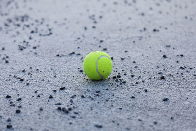 Close-up of green ball on sand