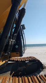 Close-up of ship sailing on sea against clear sky