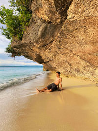 Rear view of woman swimming in sea