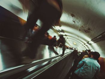 Woman standing on escalator