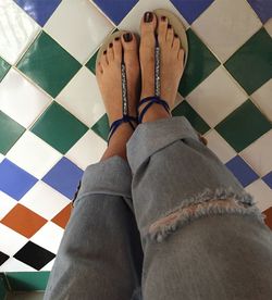 Low section of woman wearing canvas shoes