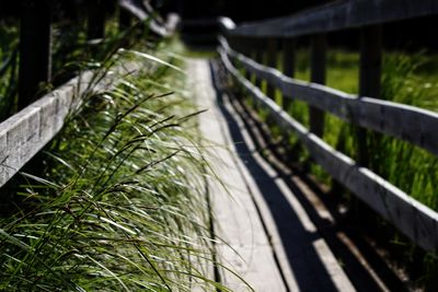 Close-up of footbridge over grass