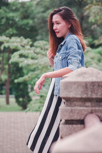 Side view of a teenage girl in park