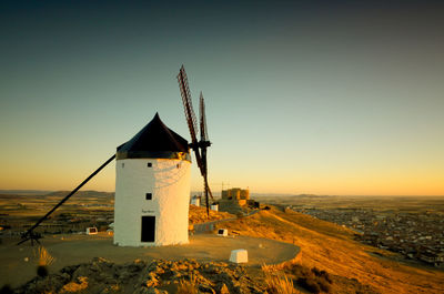 Traditional building against sky during sunset