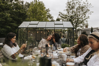 Friends having meal in garden