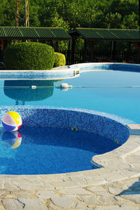 Beach ball floating on swimming pool