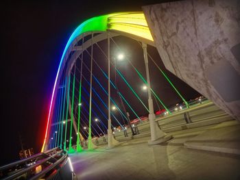 Low angle view of illuminated suspension bridge at night