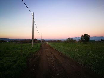 Scenic view of field against clear sky at sunset