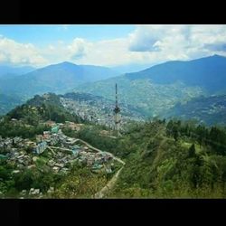 Scenic view of mountains against cloudy sky