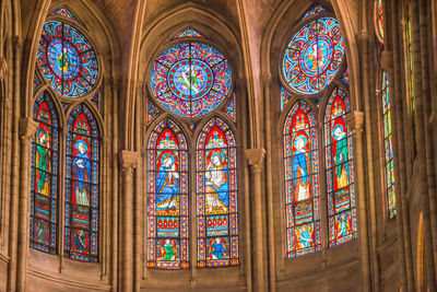 Low angle view of stained glass window in building