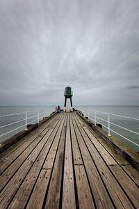 Pier over sea against sky