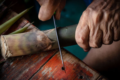 Cropped hand cutting vegetable