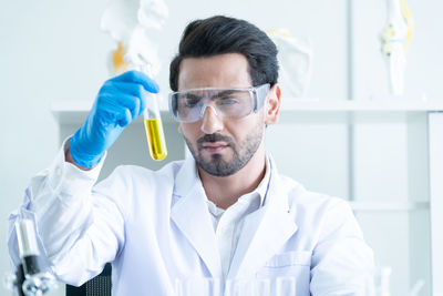 Portrait of scientist examining chemical in laboratory