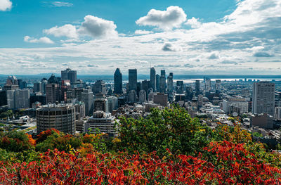 View of cityscape against cloudy sky