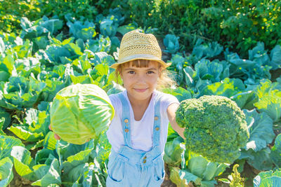 Portrait of woman standing amidst plants