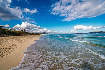 Scenic view of beach against blue sky