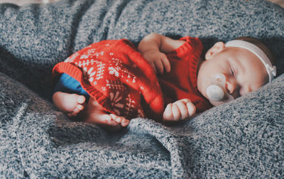 High angle view of baby sleeping on bed