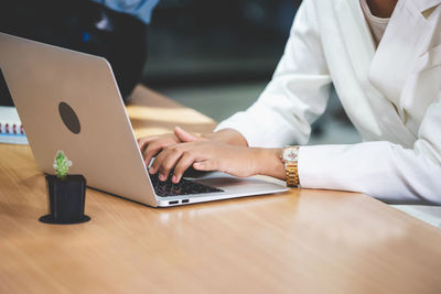 Low angle view of woman using laptop on table